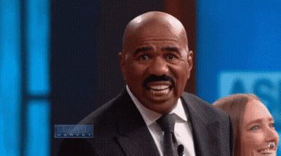 Man In Suit Making Funny Face Talking To Woman GIF