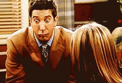 Man in Suit Making Funny Face Talking to Woman