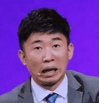 Man In Suit Making Funny Face With Microphone GIF