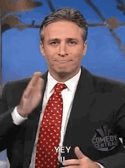 Man In Suit Making Funny Face With Thumbs Up GIF
