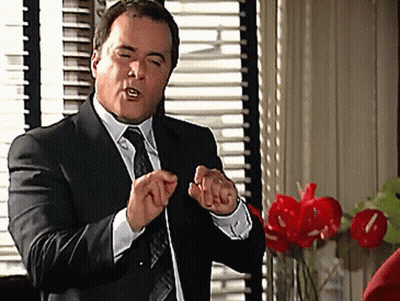 Man In Suit Making Hand Gesture GIF