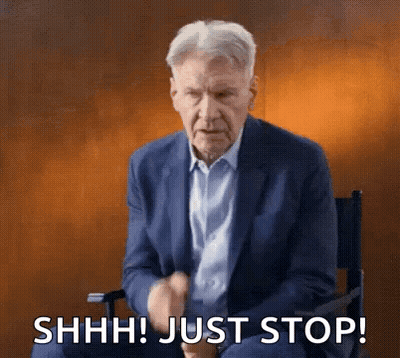 Man In Suit Making Shhh Gesture GIF