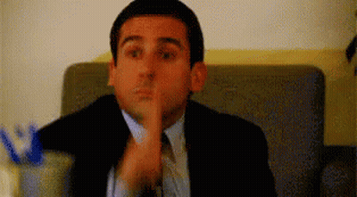 Man In Suit Making Shhh Gesture GIF