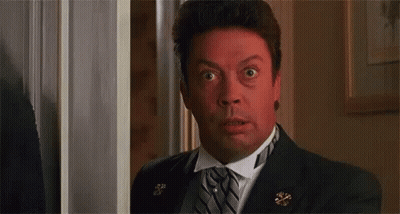 Man In Suit Making Surprised Face In Doorway GIF