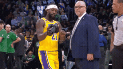Man In Suit Next To Basketball Player 21 GIF