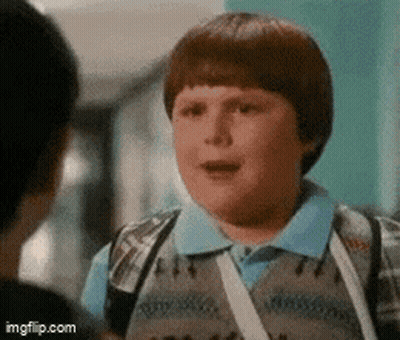 Man In Suit Next To Boy In Vest GIF