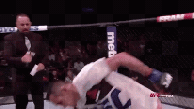 Man In Suit Next To Fighter In Cage GIF