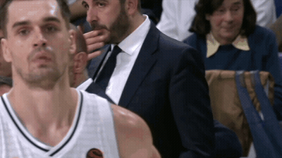 Man In Suit Next To Man In Basketball Uniform GIF