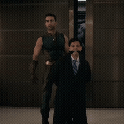 Man In Suit Next To Man In Costume GIF