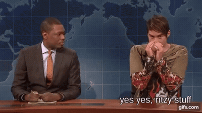 Man In Suit Next To Man In Green Shirt With Tattoo GIF