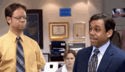 Man In Suit Next To Man In Yellow Shirt GIF