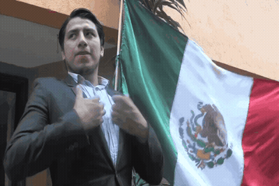 Man In Suit Next To Mexican Flag GIF