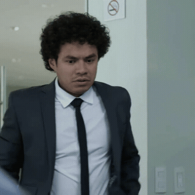 Man In Suit Next To No Smoking Sign GIF
