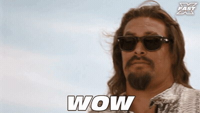 Man In Suit Next To Shirtless Man GIF