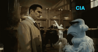 Man In Suit Next To Stuffed Animal Saying CIA GIF