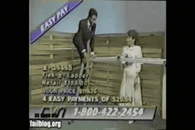 Man In Suit Next To Woman Holding Wood GIF