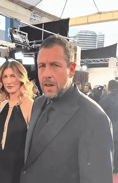 Man In Suit Next To Woman In Black Dress GIF
