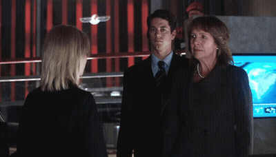 Man In Suit Next To Woman In Black Dress GIF