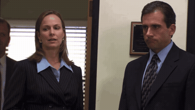 Man In Suit Next To Woman In Blue Shirt GIF