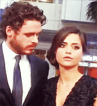 Man In Suit Next To Woman In Dress GIF
