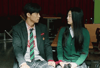 Man In Suit Next To Woman In Green Sweater GIF