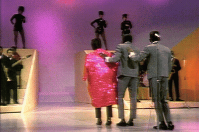 Man In Suit Next To Woman In Pink Coat GIF