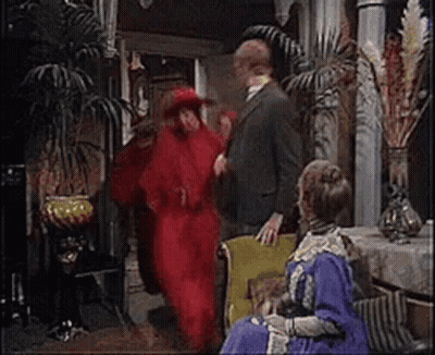 Man In Suit Next To Woman In Red Dress GIF
