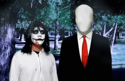 Man In Suit Next To Woman In Scary Costume GIF