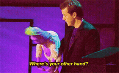 Man In Suit Next To Woman In White Dress Saying Where's Your Other Hand GIF
