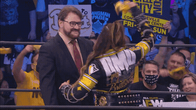Man In Suit Next To Woman In Wrestling Ring Monroeville Convention GIF
