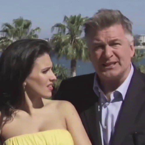 Man In Suit Next To Woman In Yellow Top GIF