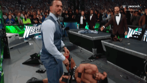 Man In Suit Next To Wrestler GIF