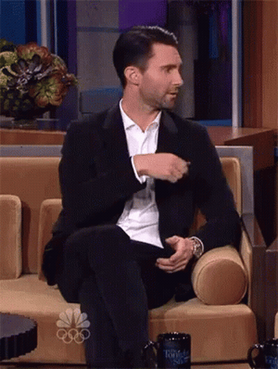 Man In Suit On Couch With NBC Cup GIF