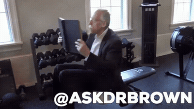 Man In Suit On Gym Bench Holding Book Askdrbrown GIF
