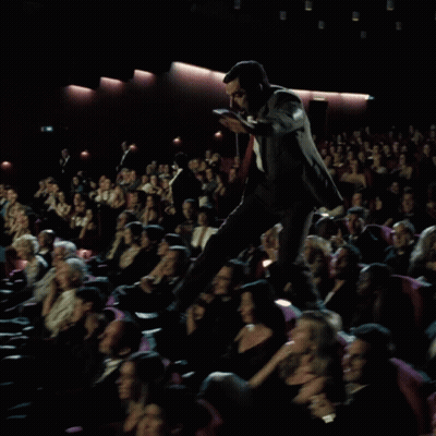 Man In Suit On Podium Before Crowd GIF