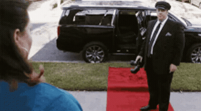 Man In Suit On Red Carpet In Front Of Car GIF