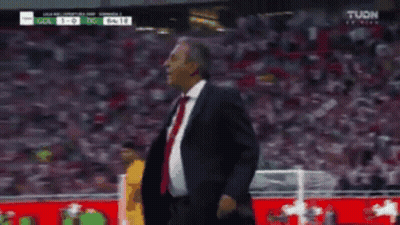 Man In Suit On Soccer Field With Referee GIF