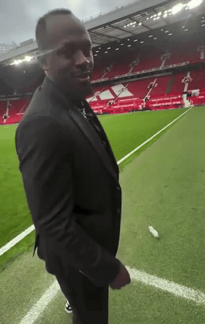 Man In Suit On Soccer Field GIF