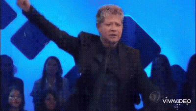 Man In Suit On Stage Arms Outstretched GIF