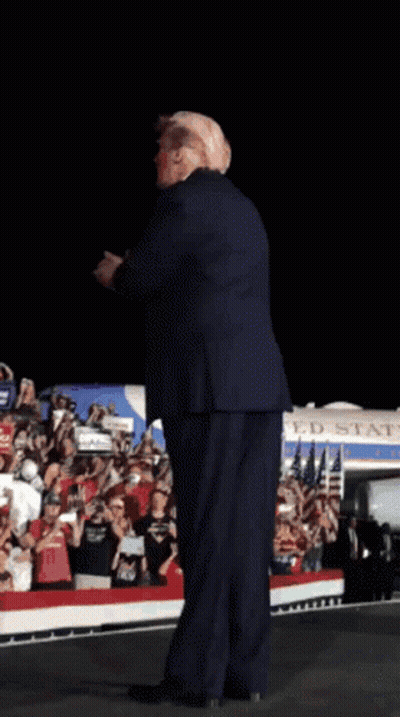 Man In Suit On Stage In Front Of Crowd GIF
