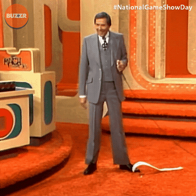 Man In Suit On Stage With Buzzr Logo GIF