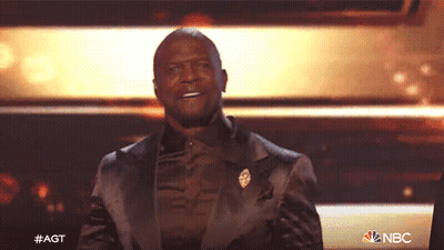 Man In Suit On Stage With NBC Logo GIF