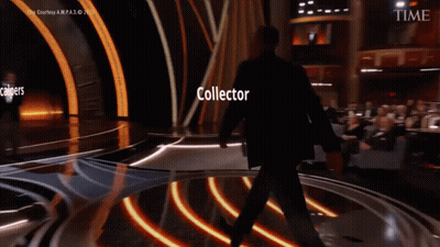 Man In Suit On Stage With Scalpers And Collector GIF