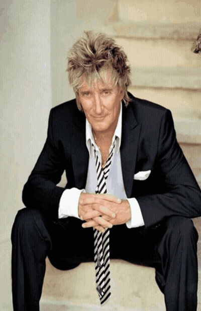Man In Suit On Stairs With Hands Folded GIF