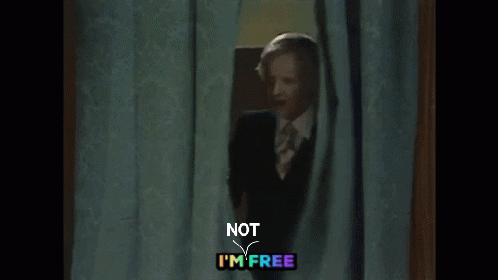 Man In Suit Peeking Behind Curtain Not I'm Free GIF