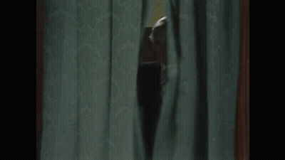 Man In Suit Peeking Through Curtain GIF