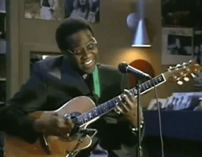 Man In Suit Playing Acoustic Guitar GIF