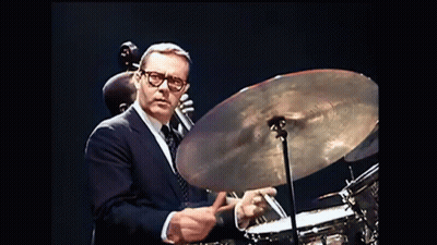 Man In Suit Playing Drum Set GIF