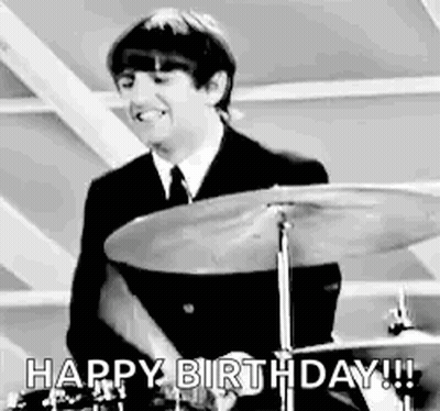 Man In Suit Playing Drum Set Smiling GIF