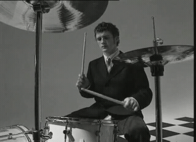 Man In Suit Playing Drums Black And White GIF